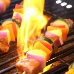 grilling meat and vegetables on gas grill