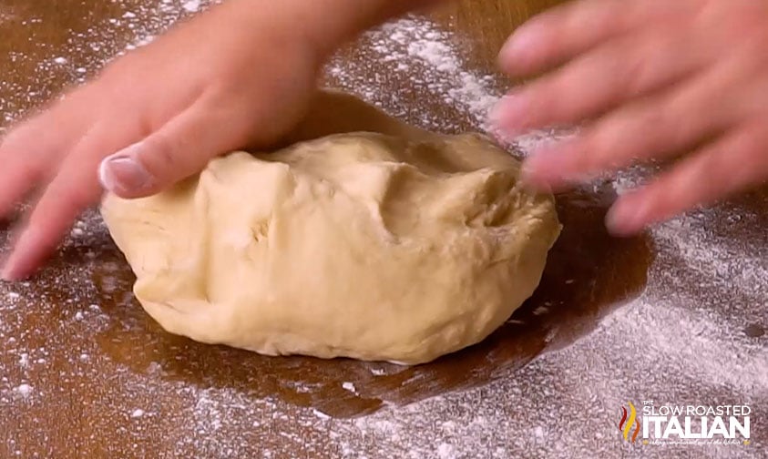 kneading a ball of dough