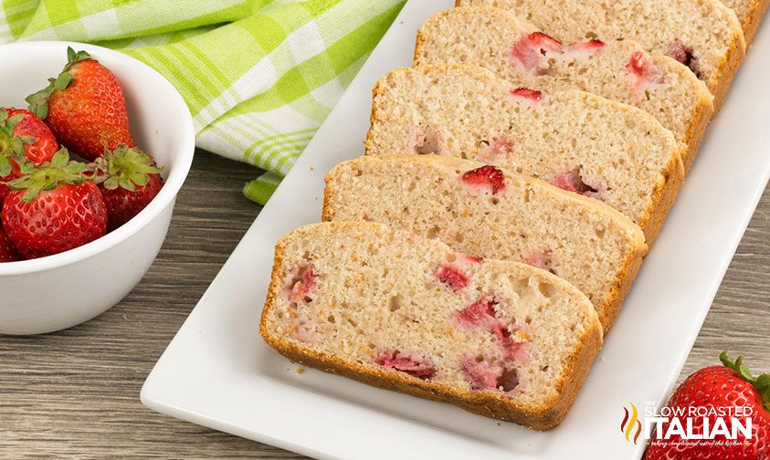 strawberry bread slices on a white rectangle platter