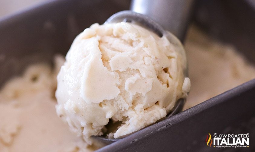 scooping dairy free banana ice cream from metal pan