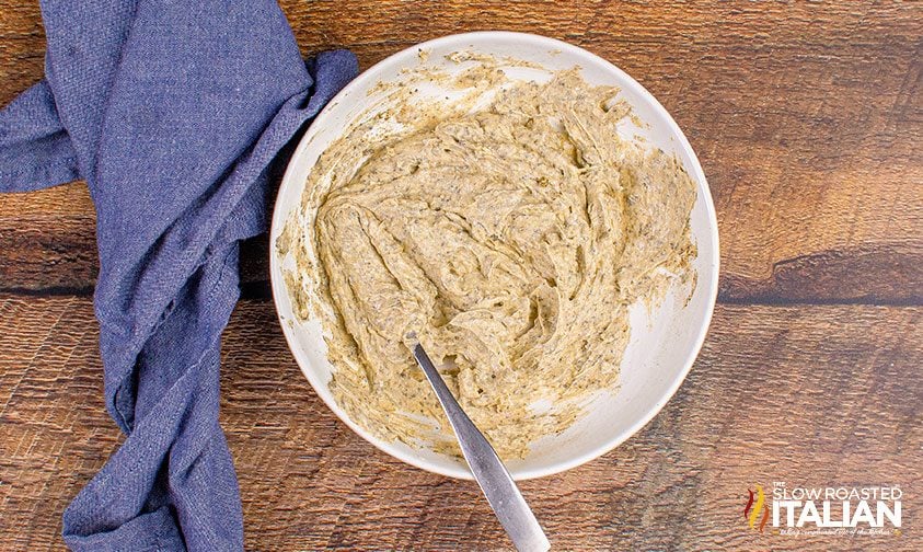 bowl of herb butter for turkey mixed with a fork