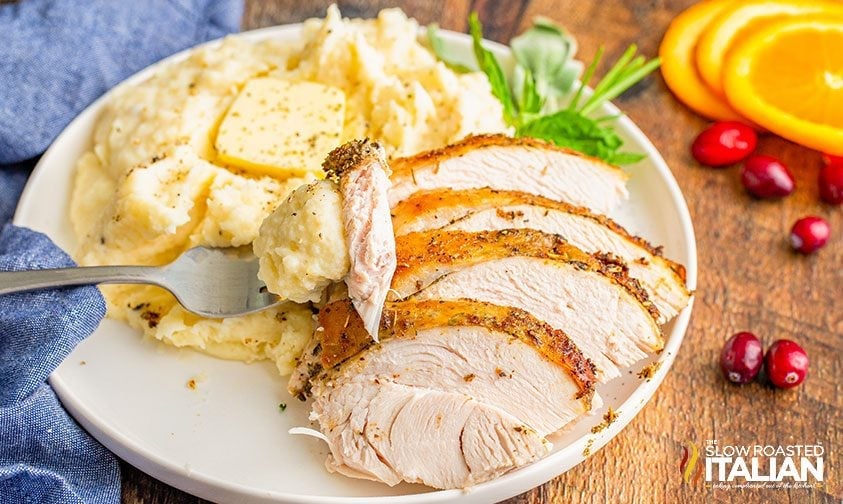 plate of sliced turkey breast and buttery mashed potatoes