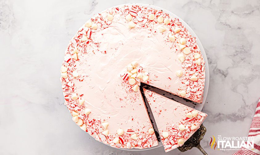 overhead: removing a slice of peppermint cheesecake