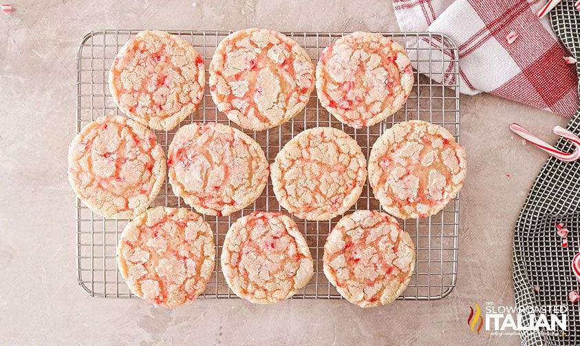 baked peppermint crinkle cookies on a wire rack