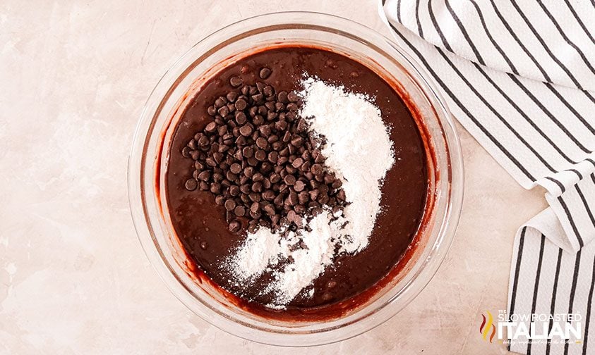 chocolate chips and flour in bowl of brownie batter