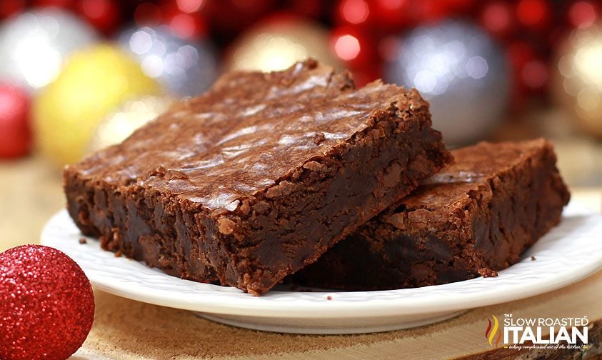 closeup: two brownie squares, stacked on a white plate