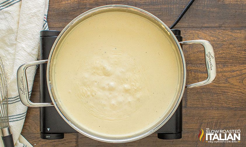 bechamel sauce simmering in a wide skillet