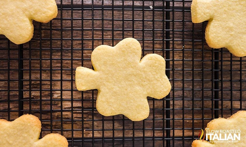 close up: baked shamrock sugar cookies on wire rack