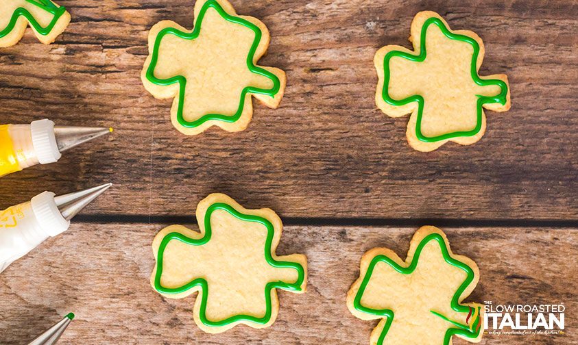 green icing border piped onto shamrock cookies