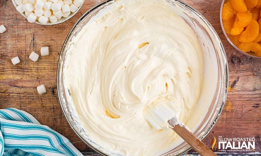 rubber spatula in a bowl of whipped cheesecake filling