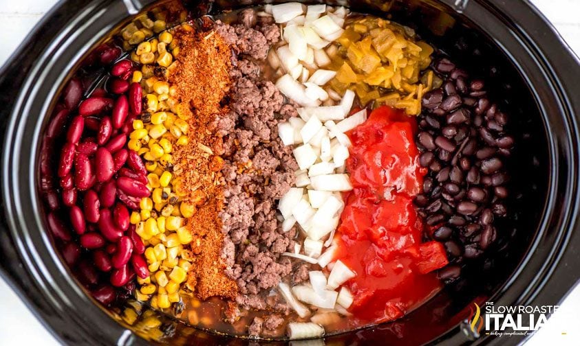 beef taco soup ingredients in a slow cooker