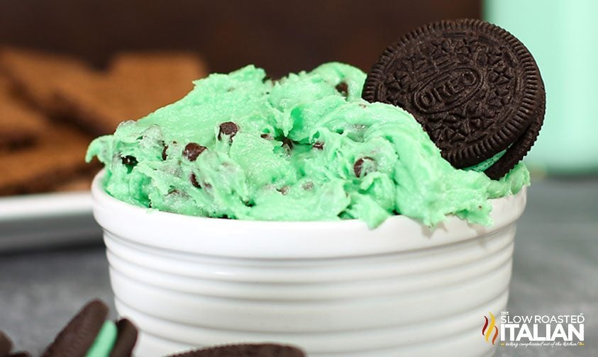 mint chocolate chip dip piled into bowl with mint oreo cookie