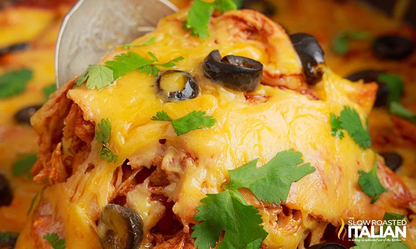 close up: scooping enchilada casserole out of slow cooker