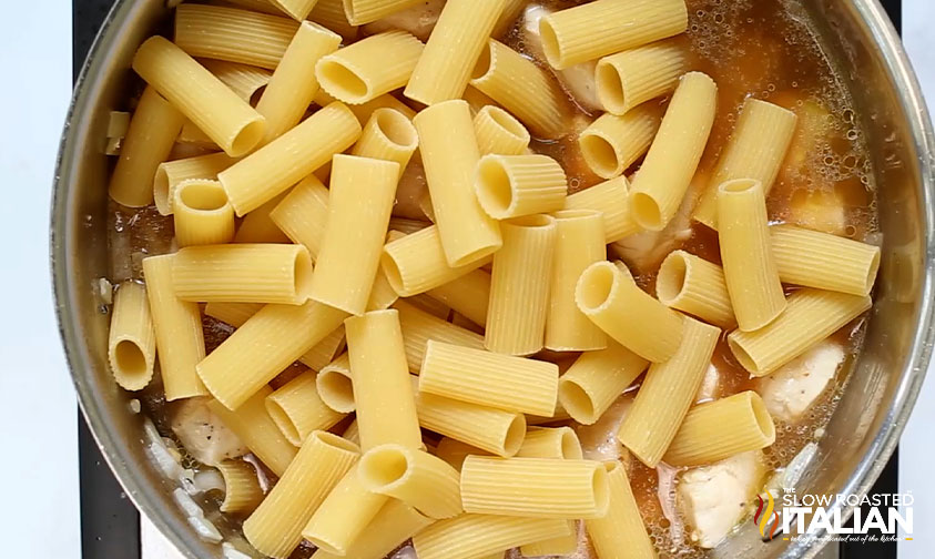 adding pasta to skillet