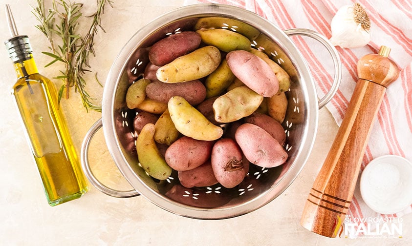 overhead: potatoes in colander next to oil and seasoning