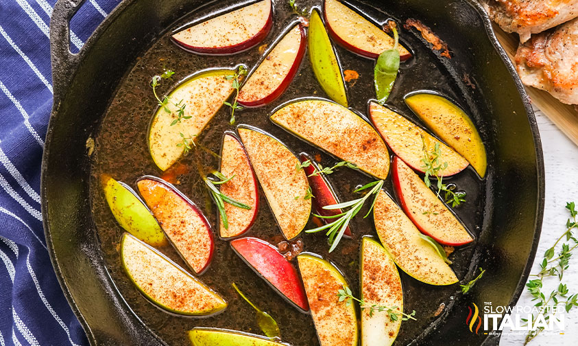 cooked apples in cast iron pan.