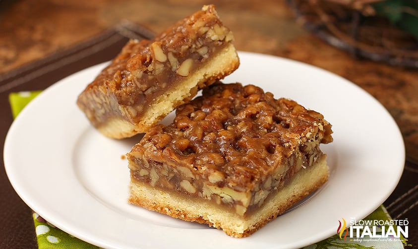 pecan pie bars on a white plate.