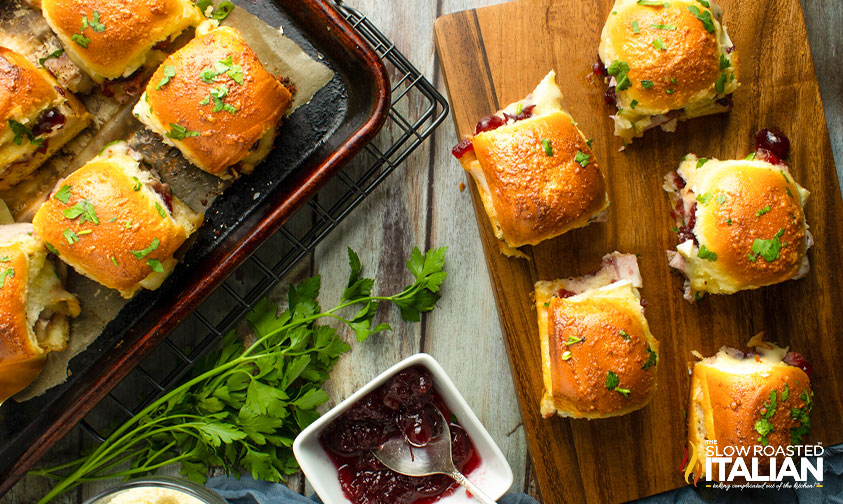 turkey and cheese sliders on cutting board.