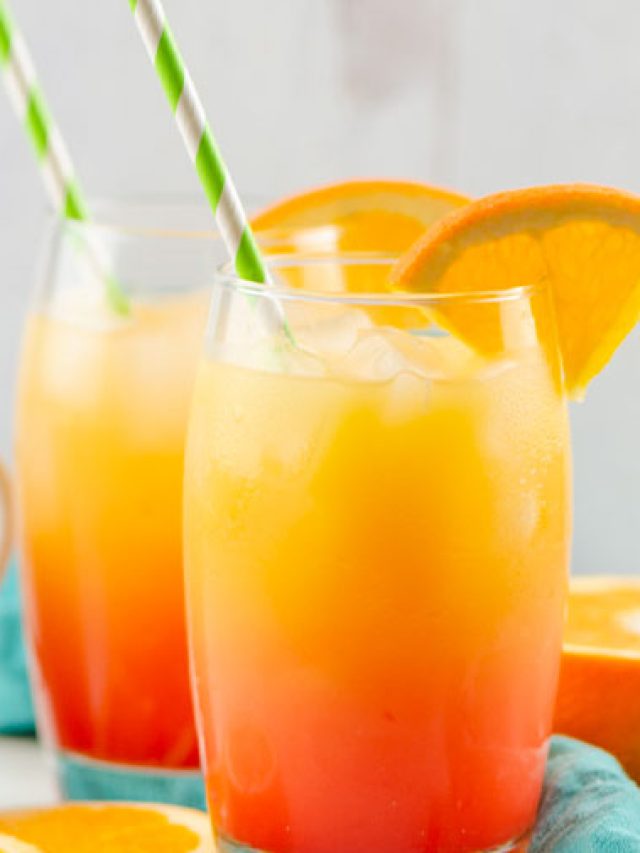 two tequila sunrise drinks with straws and orange slices