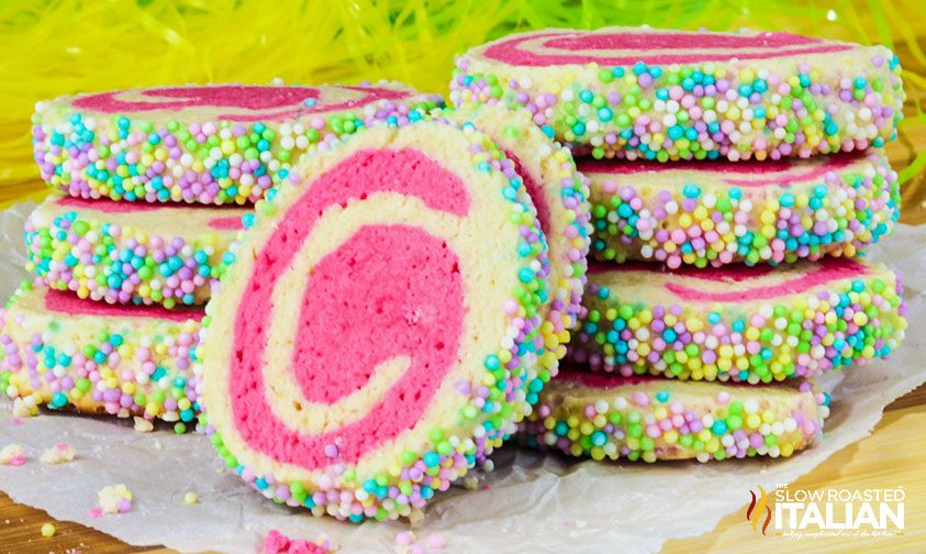 pinwheel cookies with pink swirl coated in pastel sprinkles