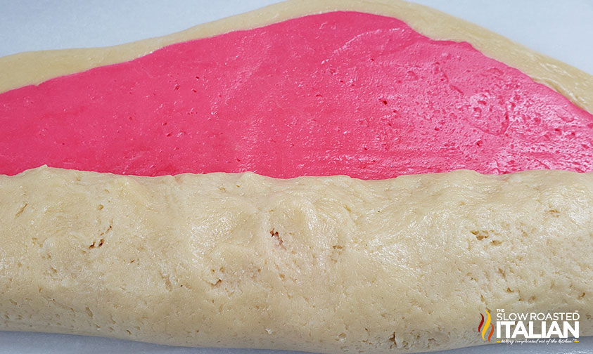 rolling plain and pink sugar cookie dough together