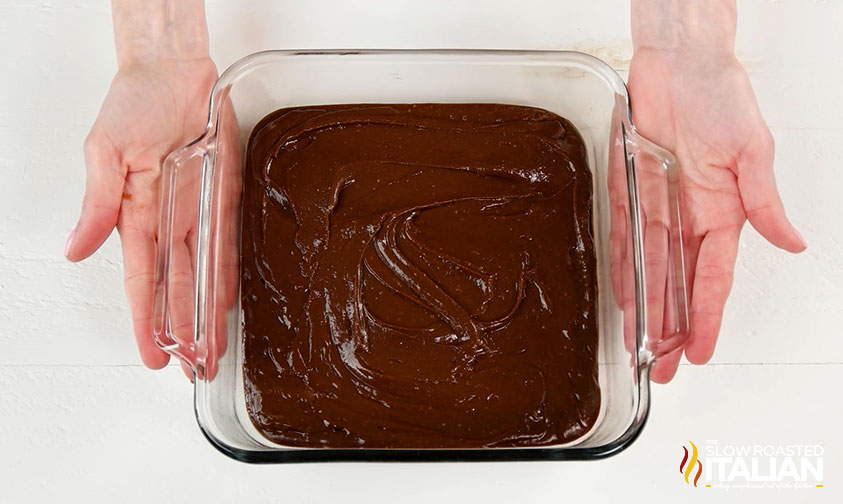 unbaked brownie batter in a glass baking dish