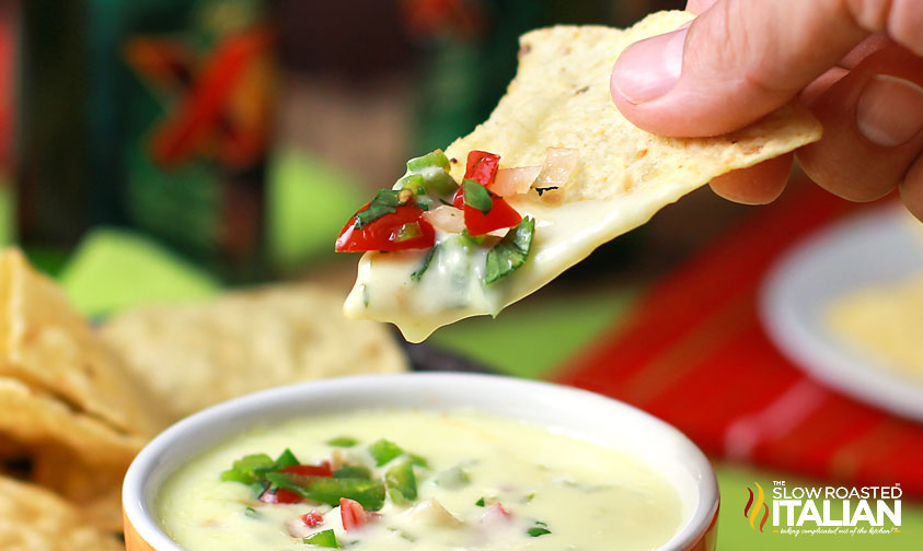 dipping chip in queso