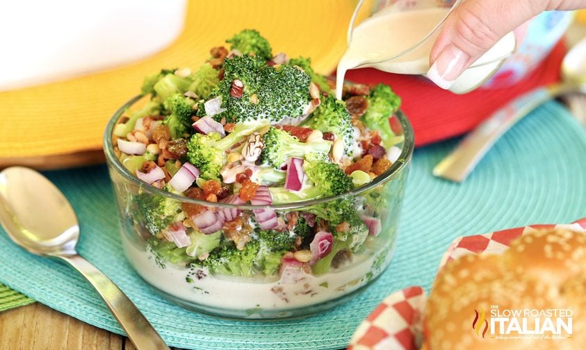 pouring creamy dressing over broccoli bacon salad