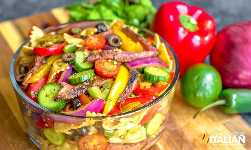 mexican pasta salad with steak in a clear bowl