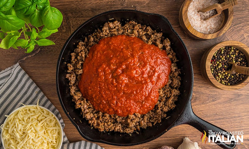 ground beef and marinara sauce in cast iron skillet