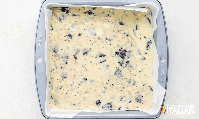 oreo fudge mixture in parchment lined baking pan