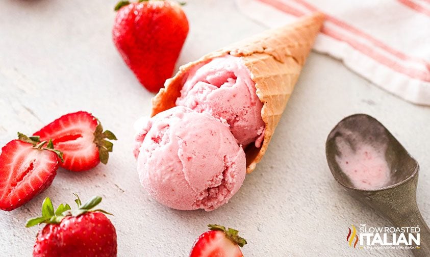 scoops of no churn strawberry ice cream in waffle cone