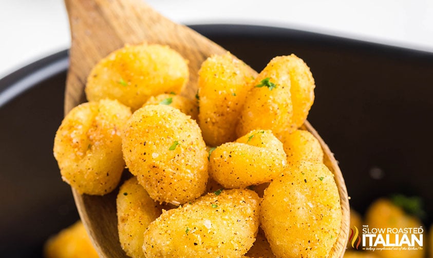 closeup of air fryer gnocchi on a wooden spoon