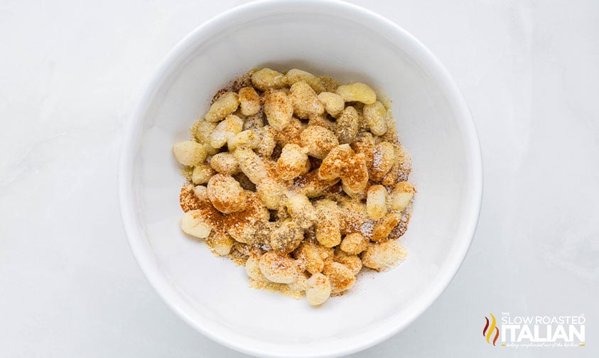 gnocchi and seasonings combined in a large bowl