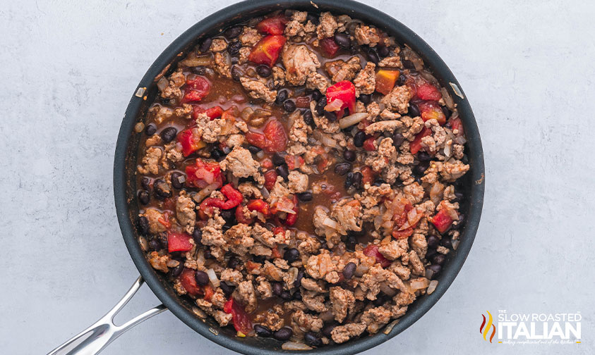 ground beef, onion, black beans and diced tomatoes cooked in a skillet