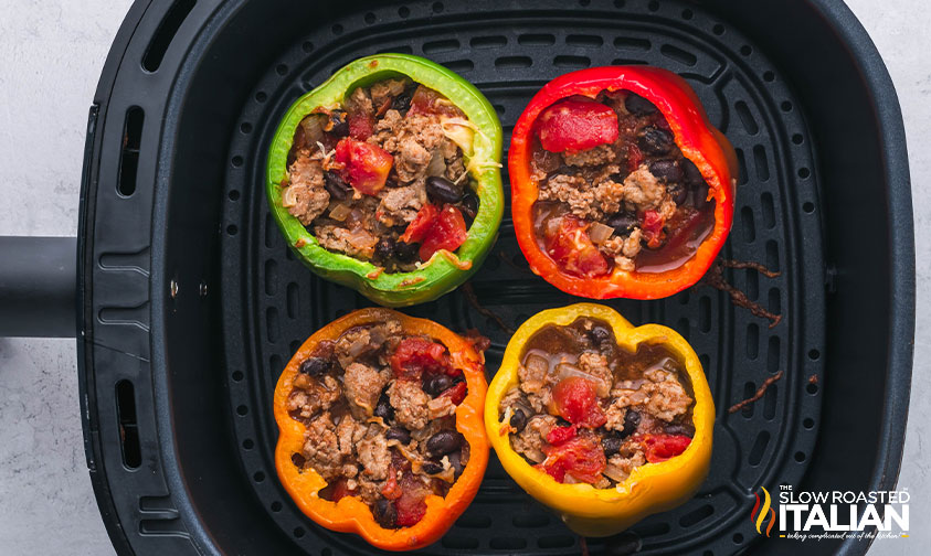 bell peppers filled with ground beef mixture in air fryer basket