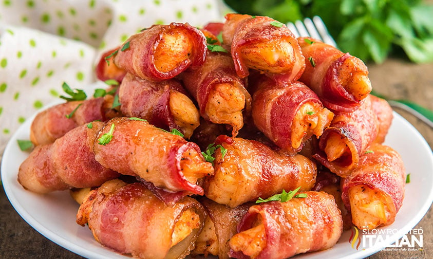 stacked bacon wrapped chicken bites on a plate