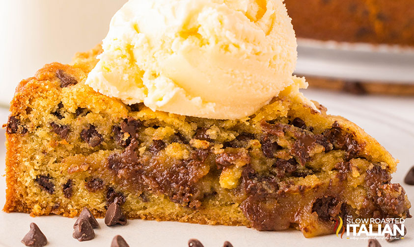 closeup of a slice of chocolate chip cookie cake with a scoop of ice cream