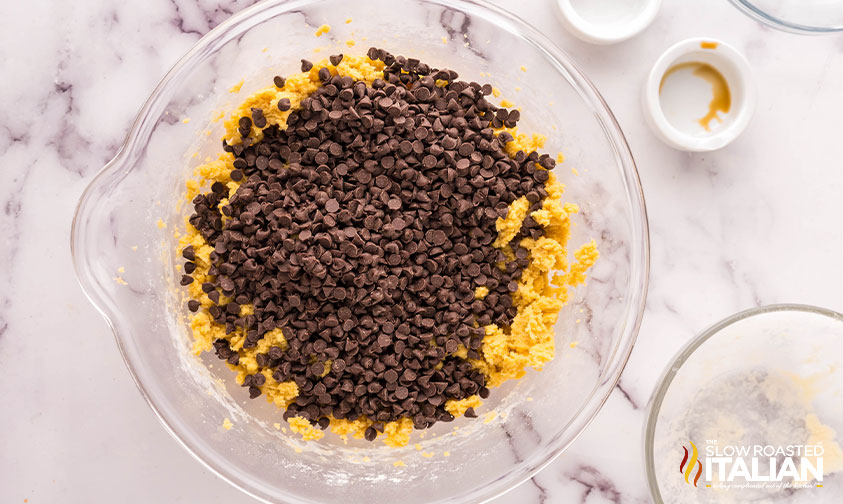 adding chocolate chips to cookie cake batter