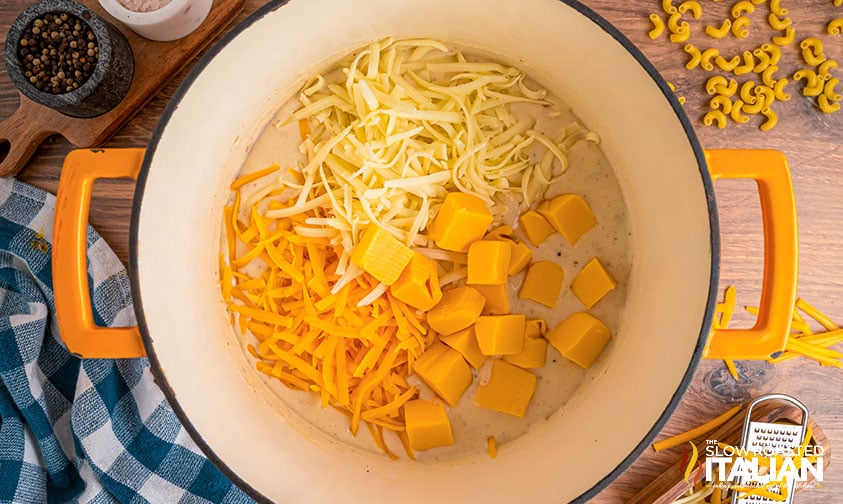 adding cheese to pot for popeyes mac and cheese recipe