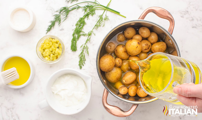 pouring pickles juice over potatoes