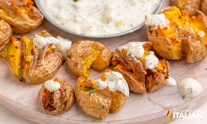 smashed potatoes on a wooden tray