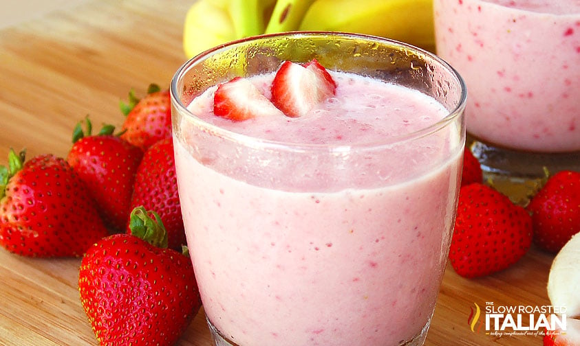 glass of strawberry banana smoothie recipe with strawberries and bananas on the side