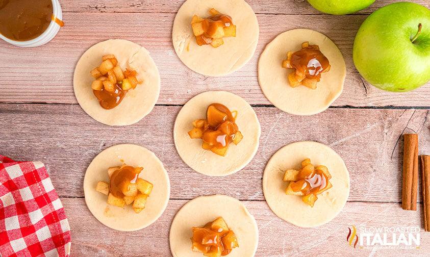 filling empanadas with caramel sauce and cooked apples