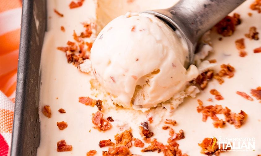 scooping maple bacon ice cream out of metal pan