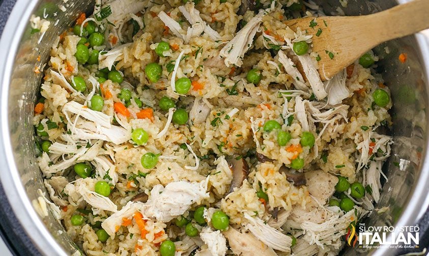 stirring peas and parsley into instant pot chicken breast and rice
