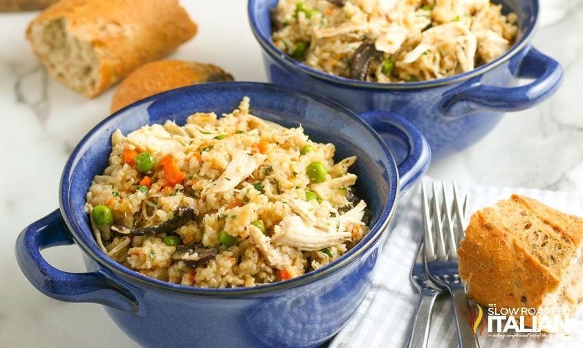 small blue bowls of chicken and rice with hunks of crusty bread