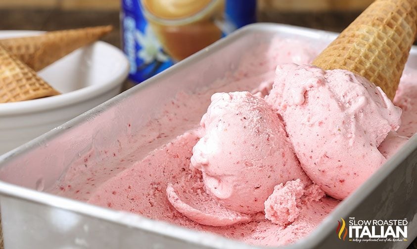 double scoop strawberry ice cream cone in metal pan