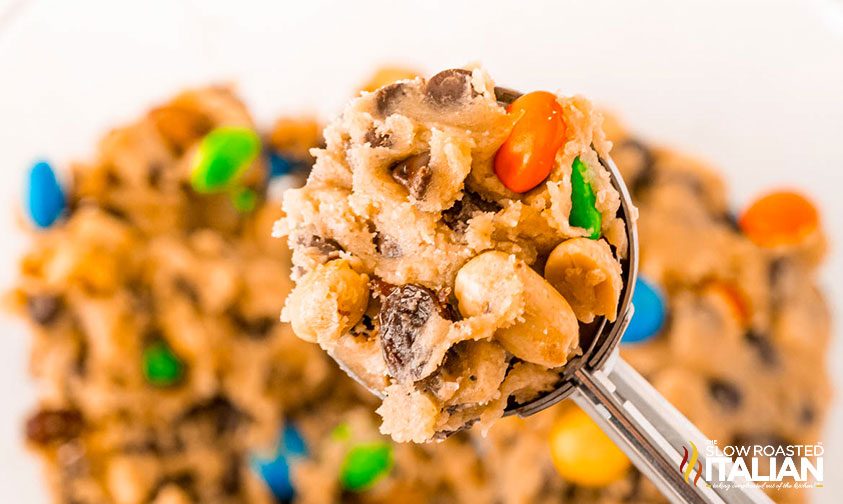 close up: cookie scoop of chocolate chip raisin cookies with peanuts and M&Ms
