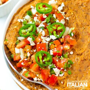 refried bean casserole in a bowl with toppings